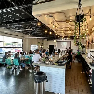 people sitting at tables in a restaurant
