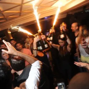 a group of people celebrating with sparklers
