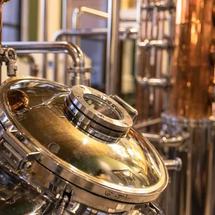a row of copper still in a brewery