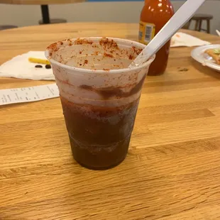 a plastic cup with a spoon in it