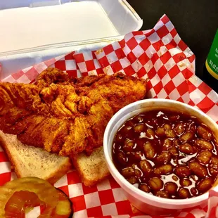 The Chicken sandwich with a side of baked beans.