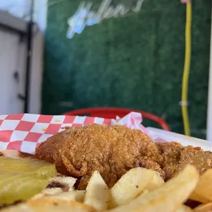 a plate of fries and pickles