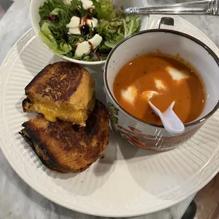 Tomato basil bread grilled cheese sandwich with tomato soup with fresh mozzarella and small salad... homemade dinner done!