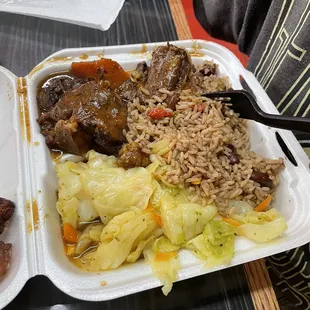 Small oxtail, steamed vegetables, rice and peas, and plantains.