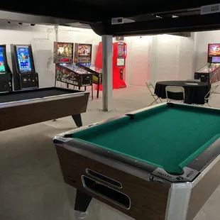 a pool table and arcade machines