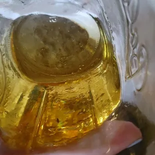 a hand holding a glass of beer