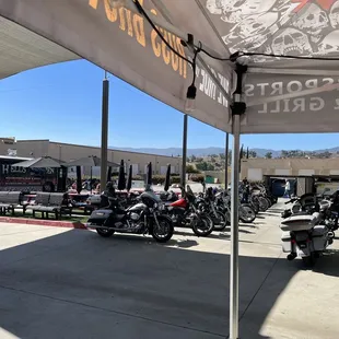 motorcycles parked under a tent