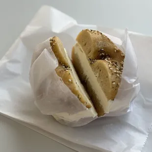 Perfectly sliced everything bagel with plain cream cheese