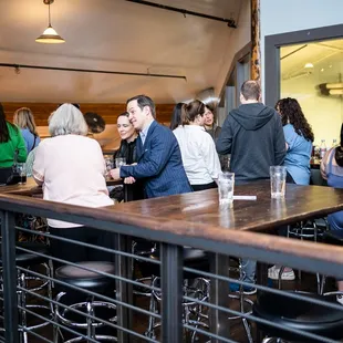 a group of people sitting at a bar