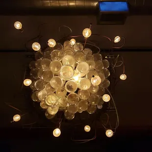 a chandelier made of beer glasses