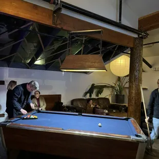 a man and woman playing pool