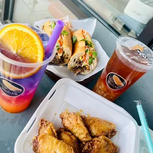 Lemongrass beef foot long sandwich and honey garlic chicken wings. Butterfly sunset tea ( the purple one) and peach tea.