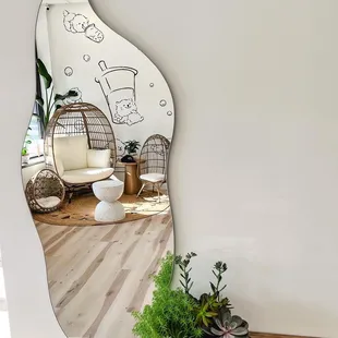 a mirror reflecting a living room