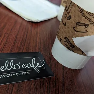 a cup of coffee and napkins on a table