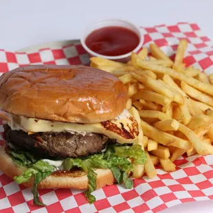 Street burger with caribbean grilled cheese, beef, egg, american chesee, bacon, lettuce, tomato and french fries.