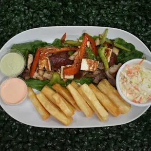 Grilled beef and chicken, sauteed with green and red peppers, compained with chorizo, fried cheese, coleslaw and fried yuca.