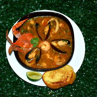 Authentic seafood soup recipe from the Caribbean accompanied with white rice.