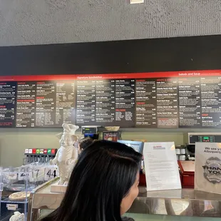 a woman ordering food at the counter