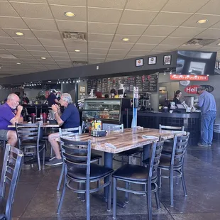 people sitting at tables in a restaurant
