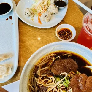 a bowl of noodles with meat and vegetables