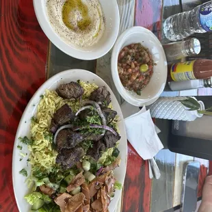 Beef skewers, fillet with rice, hummus and Salad.