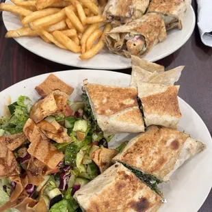 Beef and chicken rolls with salad and fries.
