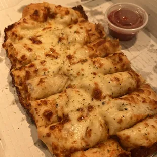 a cheesy pizza in a box