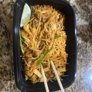 a bowl of noodles and chopsticks