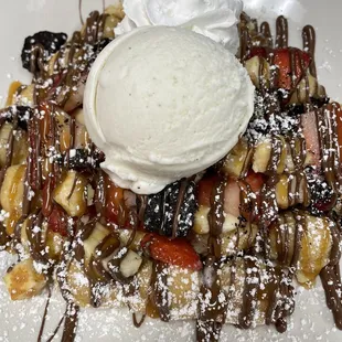 a plate of waffles with ice cream