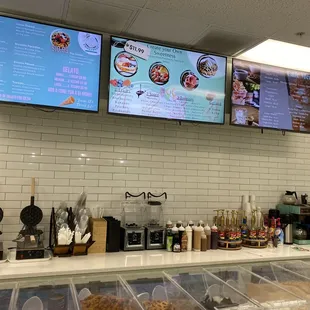 a restaurant counter with a variety of food items