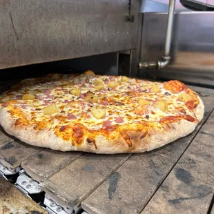 a pizza cooking in an oven