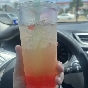 Peach tea with strawberry popping topping