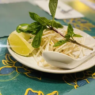 a plate of noodles and lime