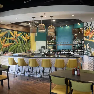 a bar with yellow chairs