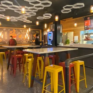 a restaurant with yellow stools