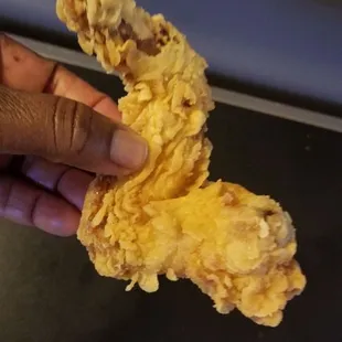 My phone makes the wing look darker but it was beige not golden brown like chicken usually is fried. It was still good though.