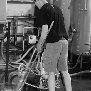 a man cleaning a brewery