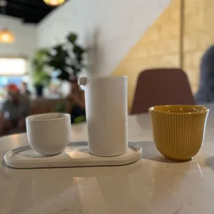 a table with a cup and saucer on it