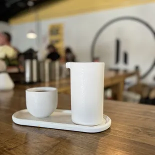 a cup and saucer on a wooden table