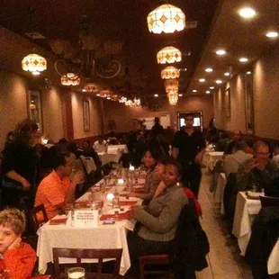 people sitting at tables in a restaurant