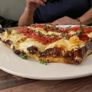 a slice of pizza on a plate