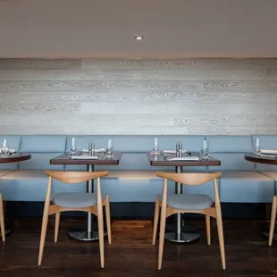 tables and booths with blue upholstered seating