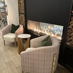 Fireplace and sitting area near dining tables.
