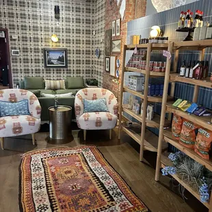 a living room with two chairs and a rug