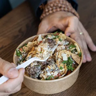 a person eating a bowl of food