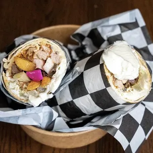 two burritos wrapped in black and white checkered paper