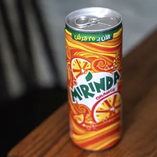 a can of drink on a table