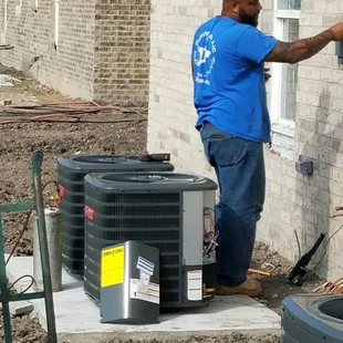 Lead Tech Nick installing a condenser unit.