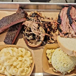 Three meat BBQ Plate with ribs, pulled pork, and brisket with sides of mac &amp; cheese and potato salad.