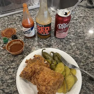 a plate of fried chicken and pickles